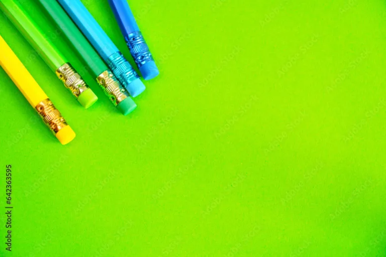 lapices de colores y gomas de borrar sobre un fondo plano de color verde espacio para escribir y componer stockpack adobe stock jpg